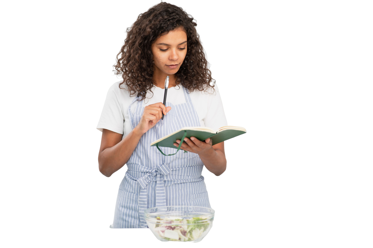 woman-writing-notebook-kitchen.png